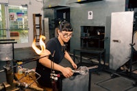 a woman working in a glass studio